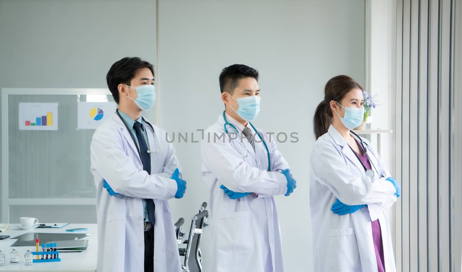 The virus is spreading strongly. Medical team Asian people wear protective masks and meeting together at the hospital.