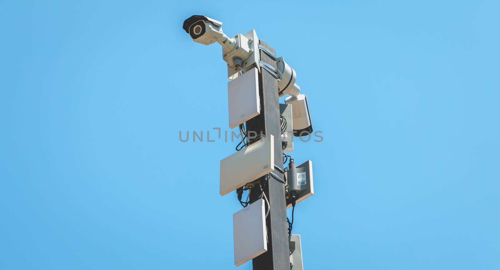 Barcelona, Spain - June 21, 2017: surveillance camera and GSM antenna on a pylon in the city center on a summer day