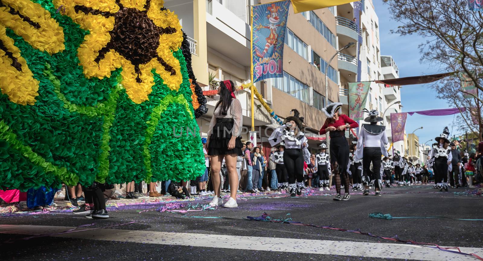 Loule, Portugal - February 25, 2020: dancers parading in the street in front of the public in the parade of the traditional carnival of Loule city on a February day