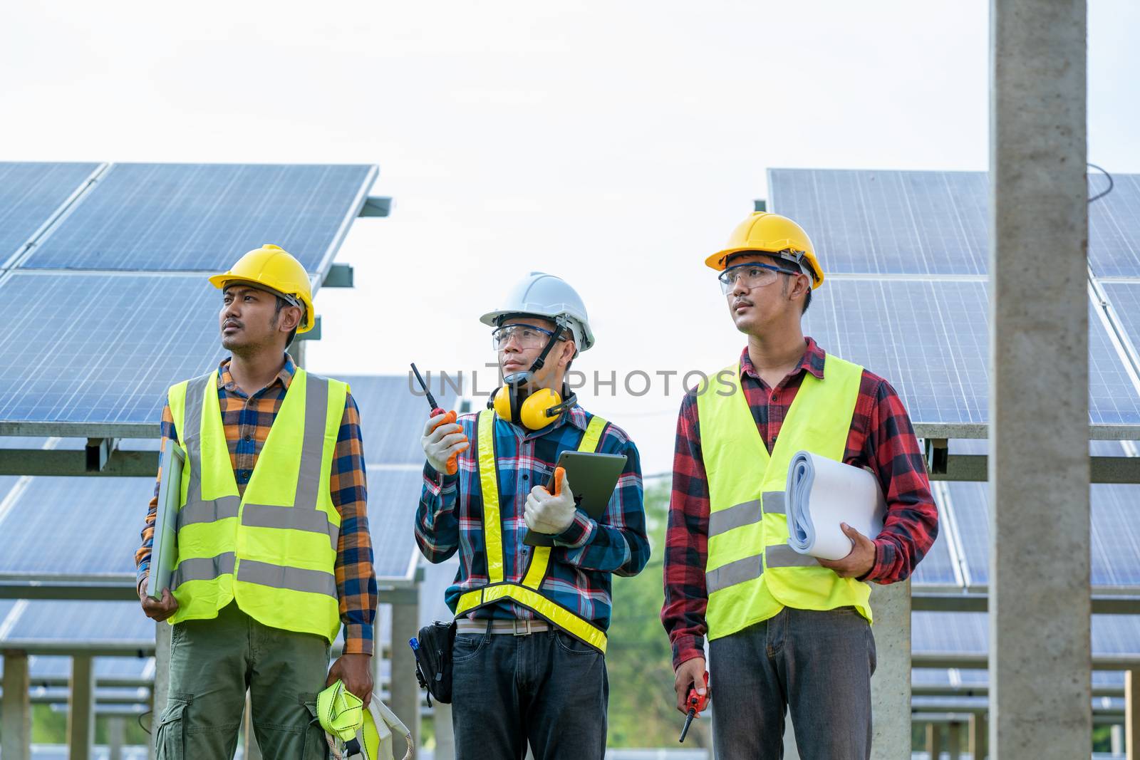 Engineer and technician discussion plan to find problem of solar panel,Engineer working on checking and maintenance in solar power plant,Solar power plant to innovation of green energy for life.