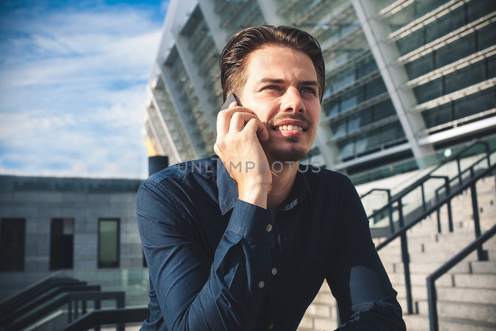 Happy businessman stand on stairs and dreaming about something.