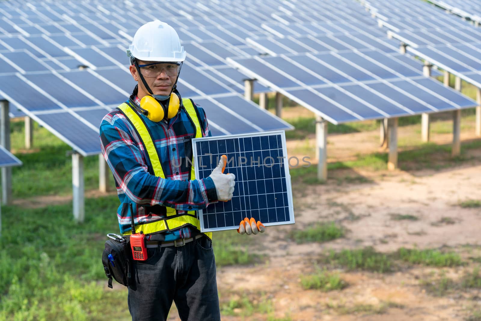 Engineer checking solar panel in routine operation by Visoot
