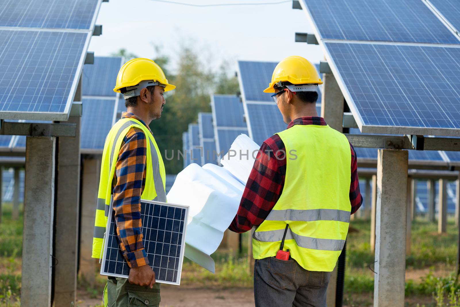 Group of engineer checking solar panel in routine operation by Visoot