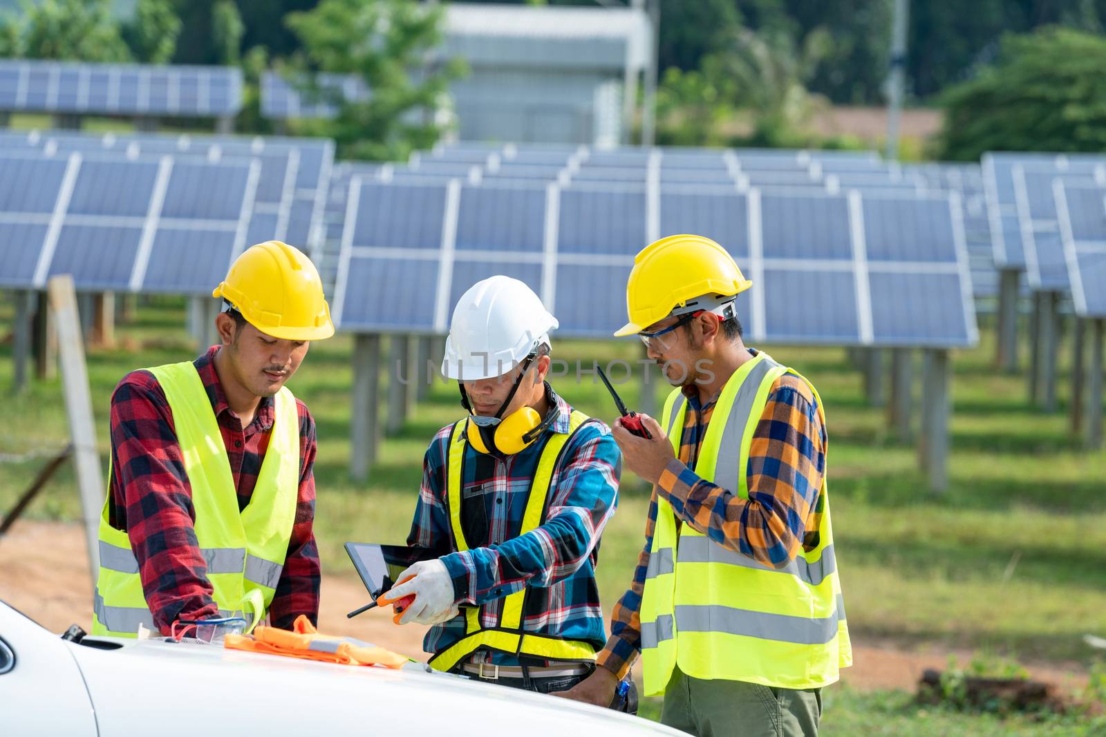 Engineer and technician discussion plan to find problem of solar panel,Engineer working on checking and maintenance in solar power plant,Solar power plant to innovation of green energy for life.