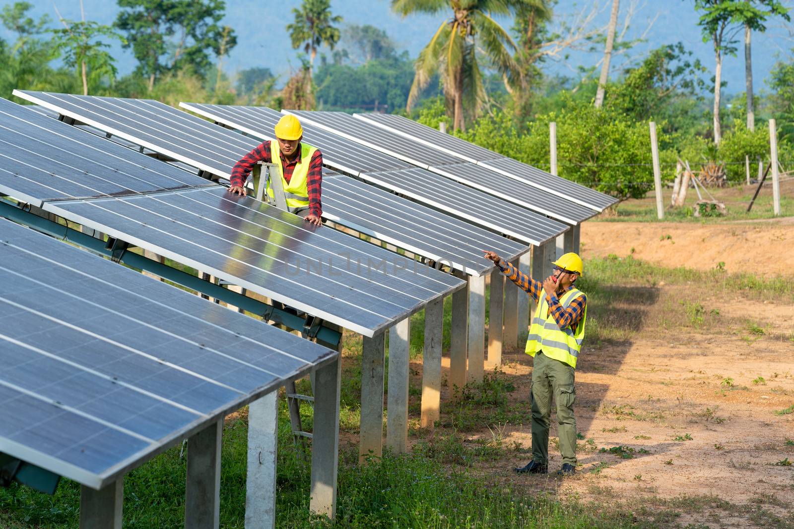 Group of engineer checking solar panel in routine operation by Visoot