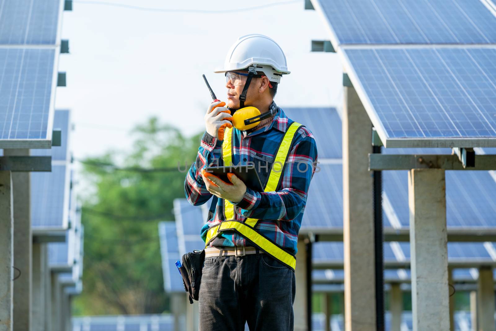 Solar power plant,Engineer working on checking and maintenance in solar power plant on a background of photovoltaic panels,Science solar energy.