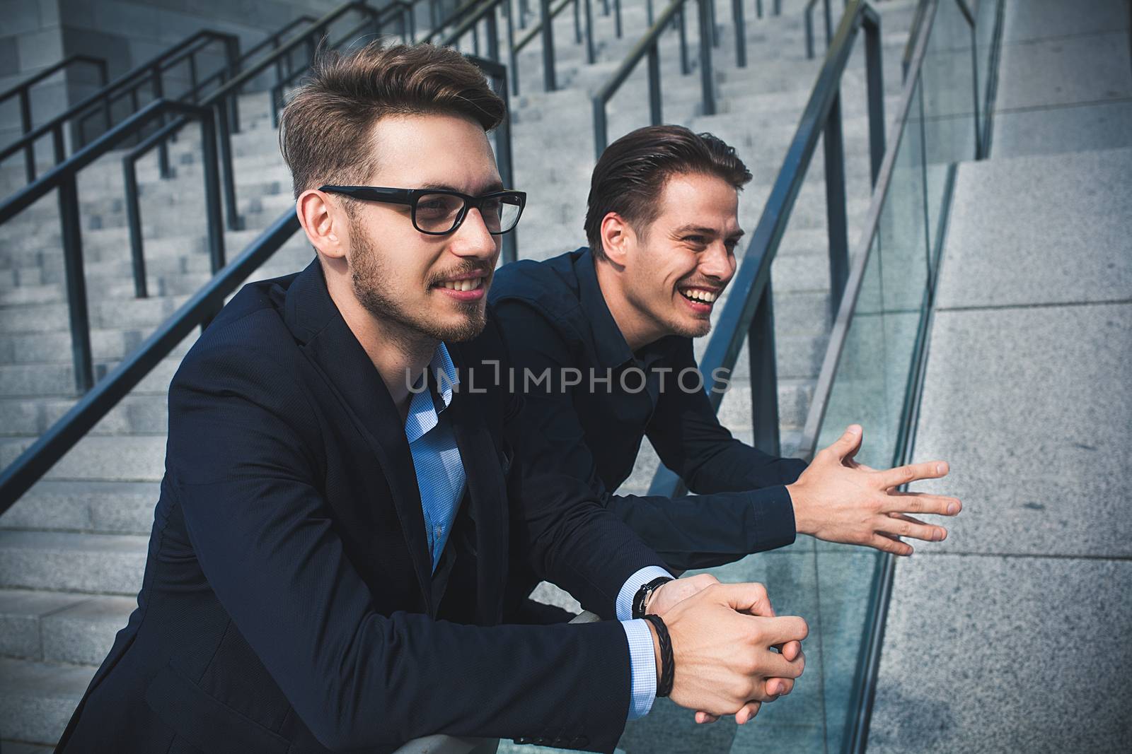 Two awesome businessman have a rest between a work. Speak easy