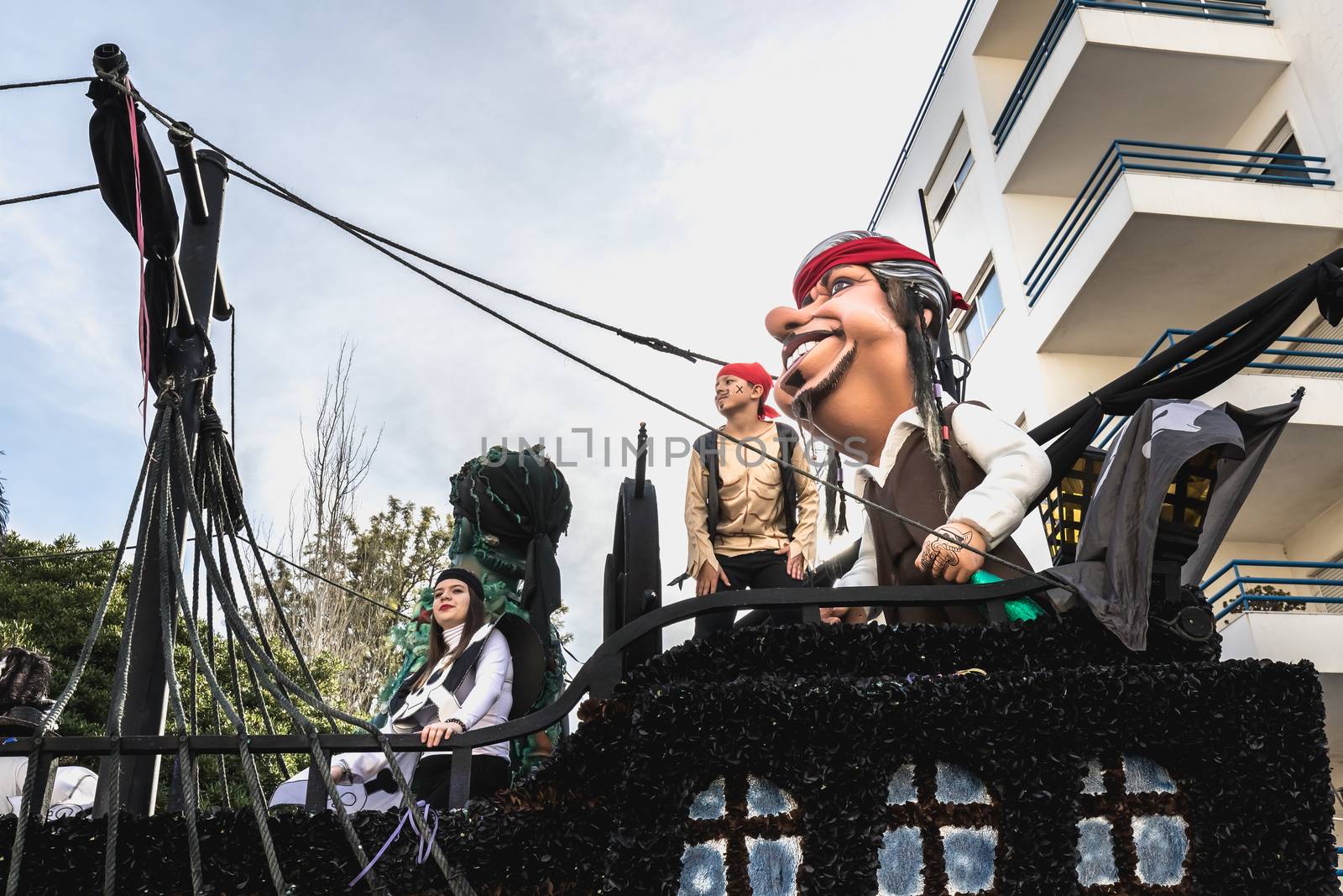 Loule, Portugal - February 25, 2020: Float parading in the street in front of the public in the parade of the traditional carnival of Loule city on a February day