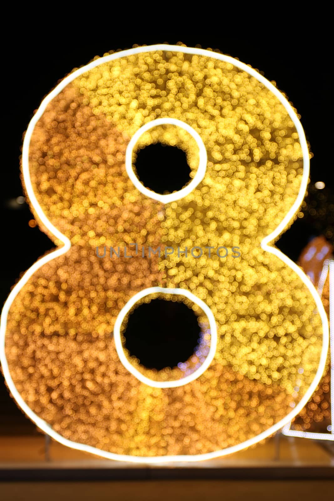 Alphabet Number Eight Gold, Blurred Bokeh letter eight (8) gold font type colorful lighting Glittering shine yellow on night black background
