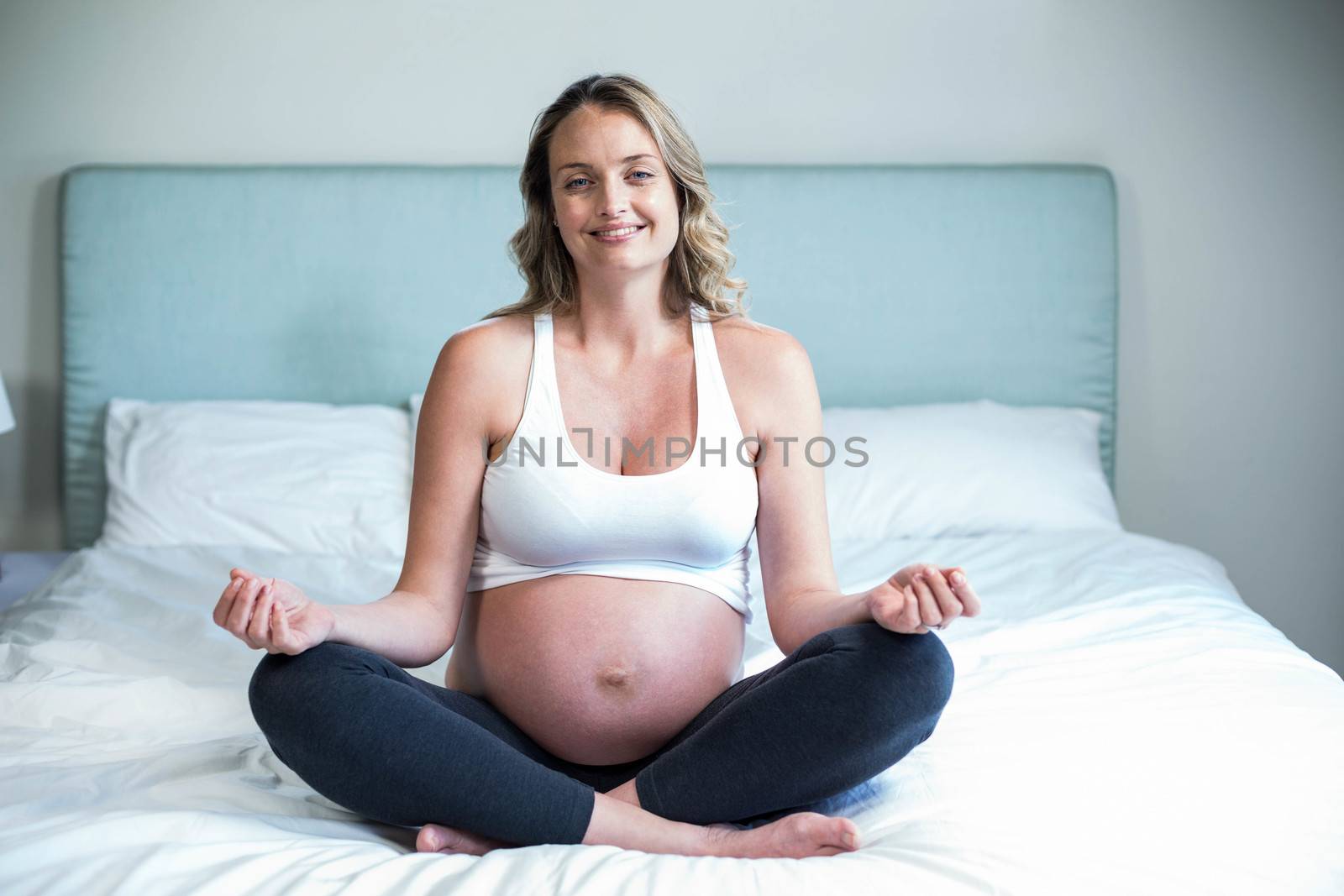Pregnant woman doing yoga by Wavebreakmedia