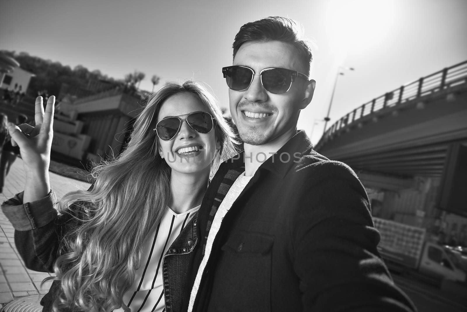 Happy young couple in love takes a selfie portrait by Nickstock