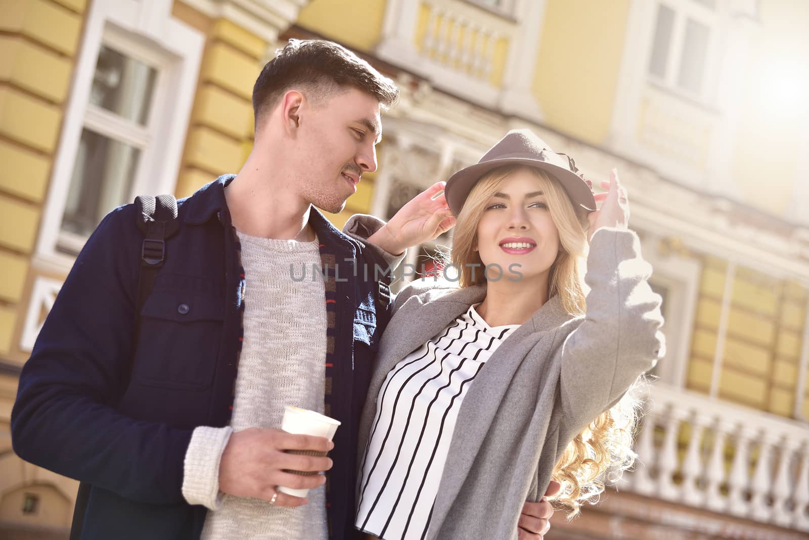 Stylish couple walking at the street having fun