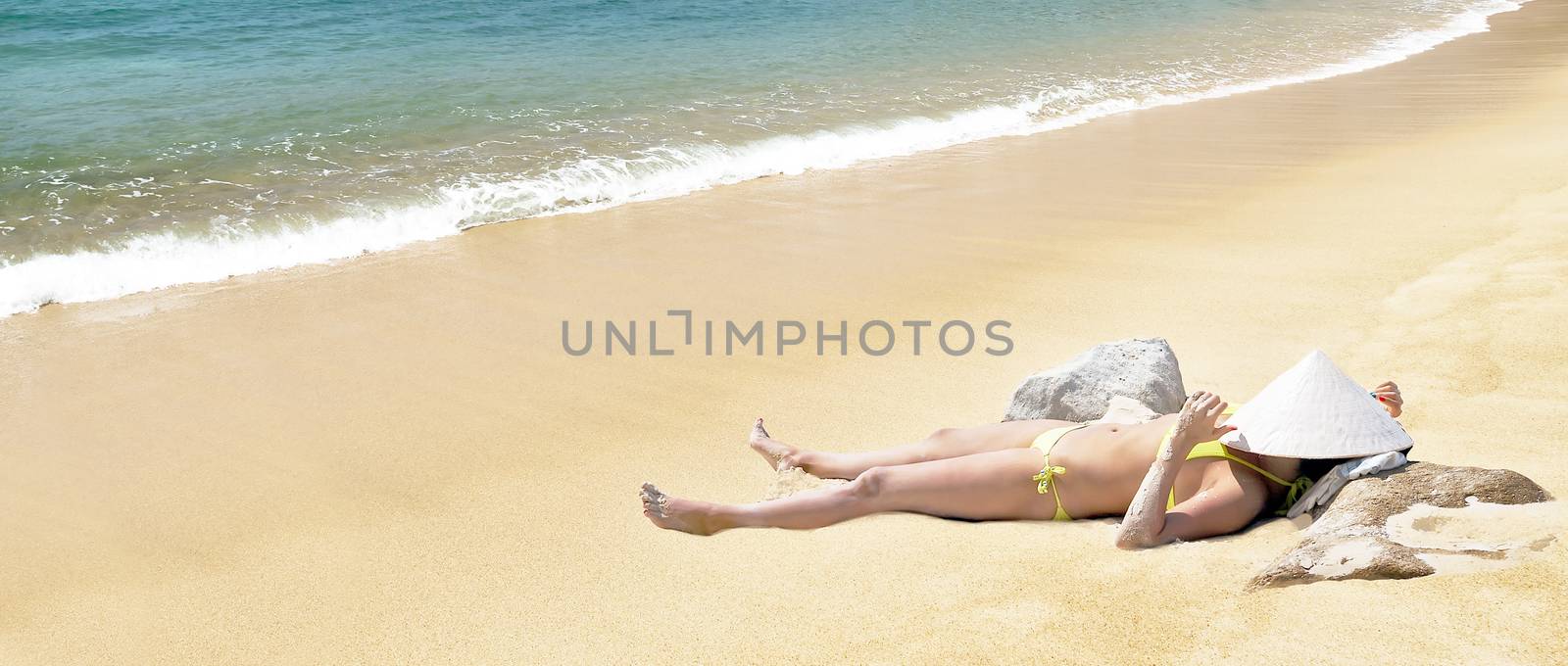 Panoramic view young woman sexy in bikini and chinese conical straw hat relaxing at white sand beach at the clear blue waters