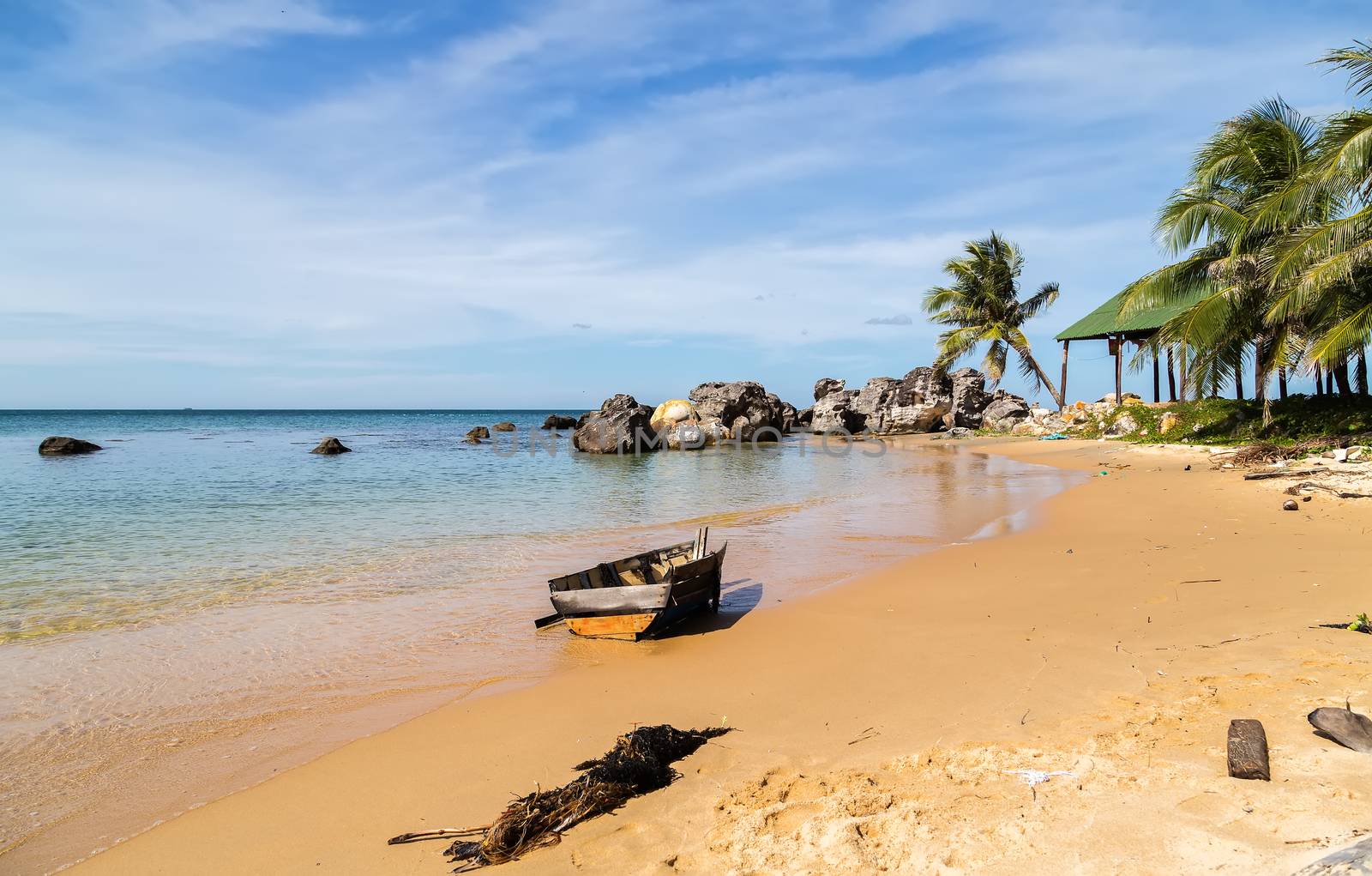 Old wooden shipwreck by the coast of the island, granite rocky beaches on tropical sea. landscape summertime seychelles