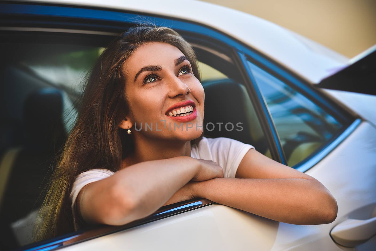 Portrait of a handsome girl driving her car