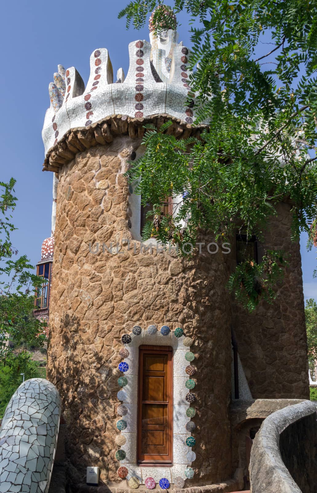 Frame ceramic tile grunge background covered with tile-shard mosaic, Parc Guell designed by Antoni Gaudi located on Carmel Hill, Barcelona, Spain.