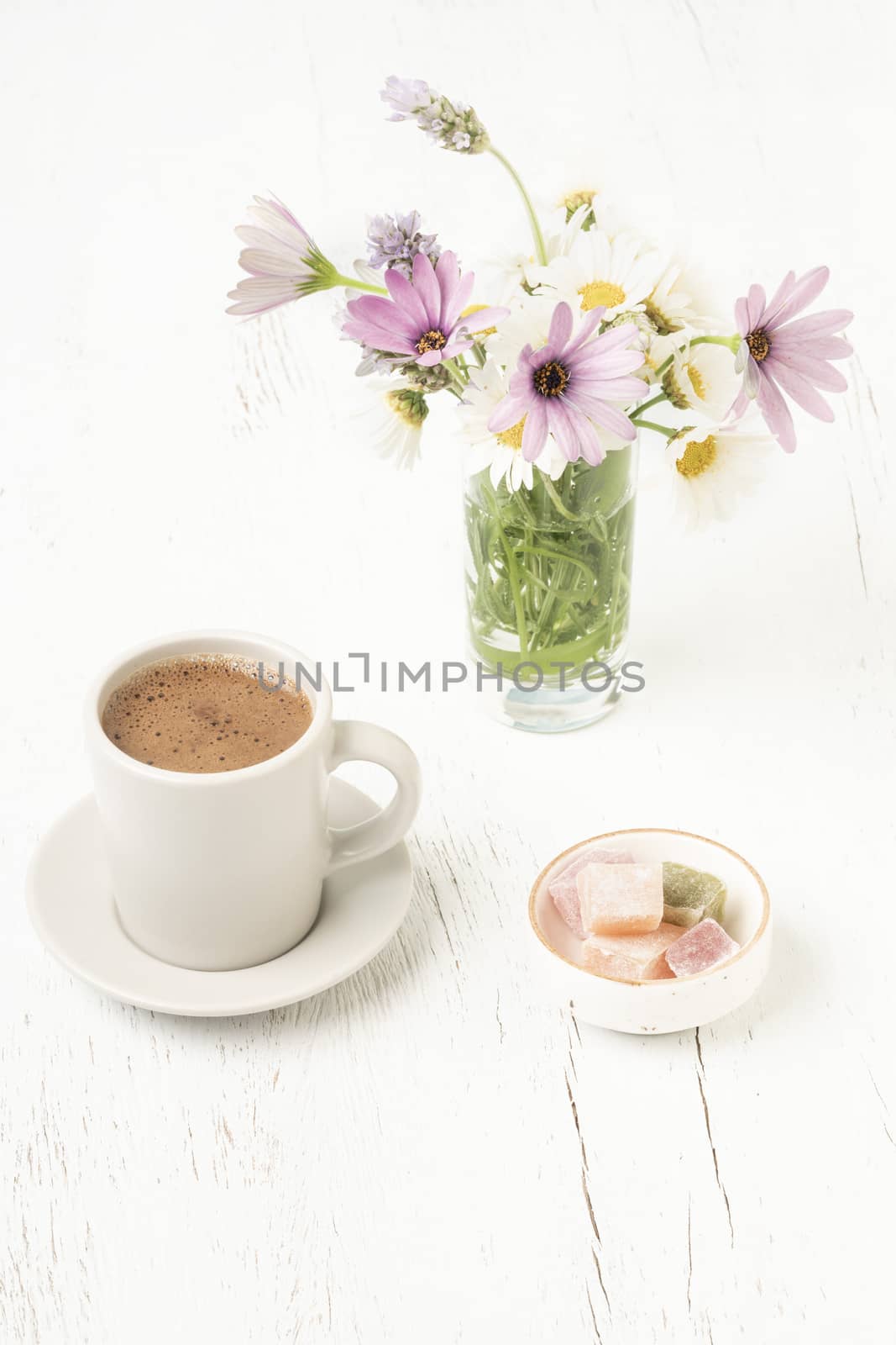 coffee and Turkish delights on table with flowers by bernanamoglu