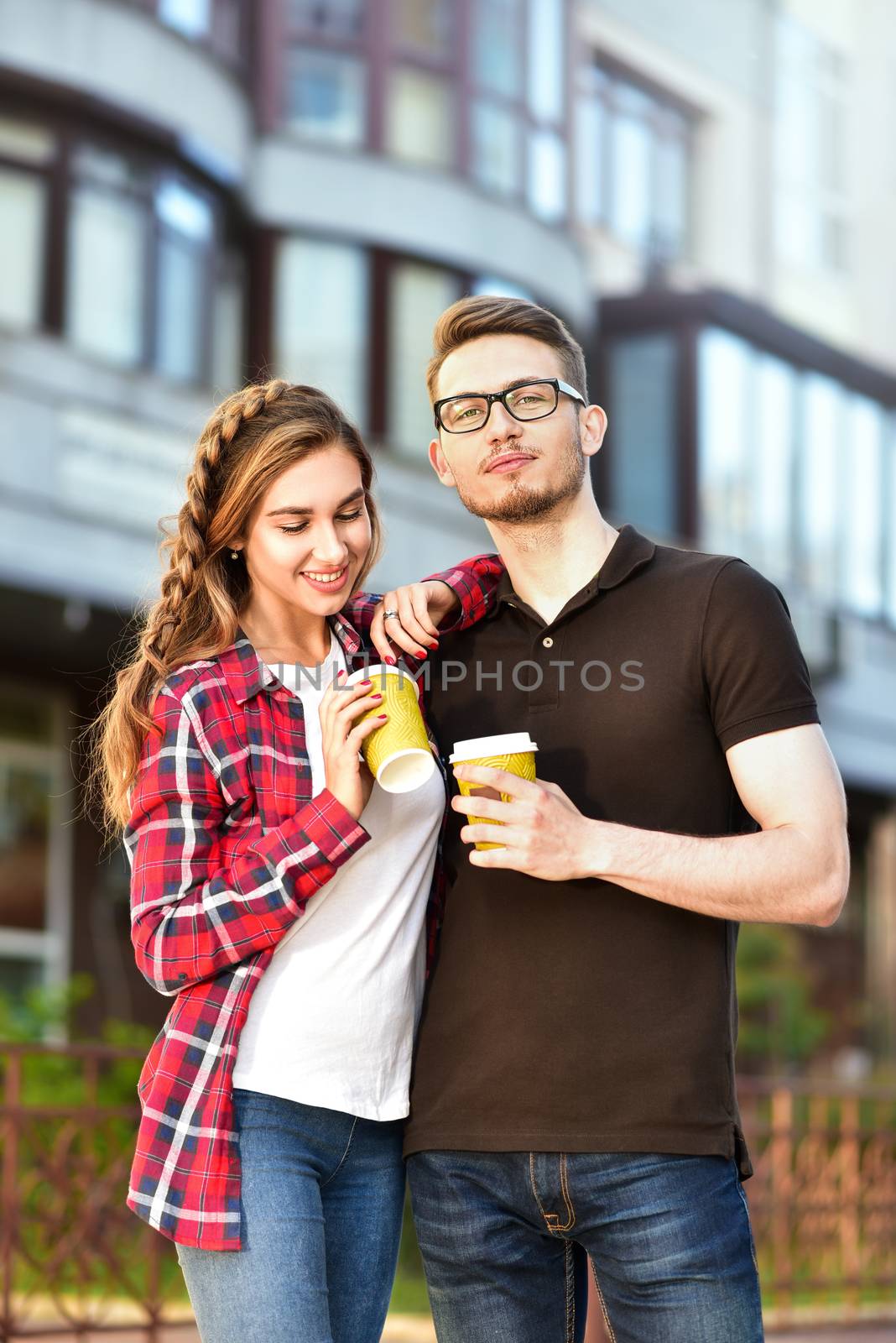 Portrait of happy couple walk on the street with coffee