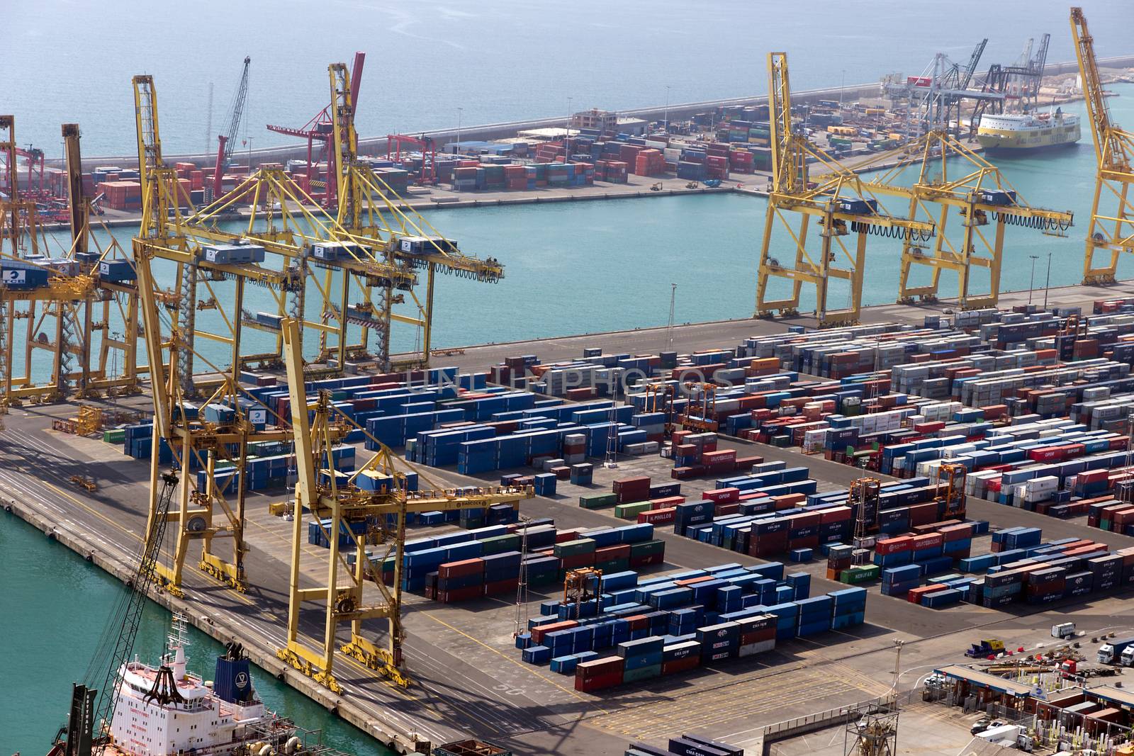 BARCELONA, SPAIN - AUGUST 27, 2012: Terminal Port Nou, Сontainer ship in import export and business logistic, By crane, Trade Port, Ship, cargo to harbor Barcelona. Catalonia, Spain.