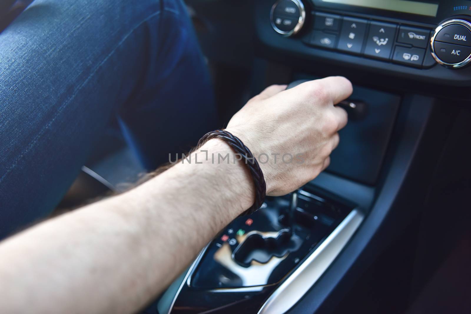 Hand Holding Automatic Transmission In his Car