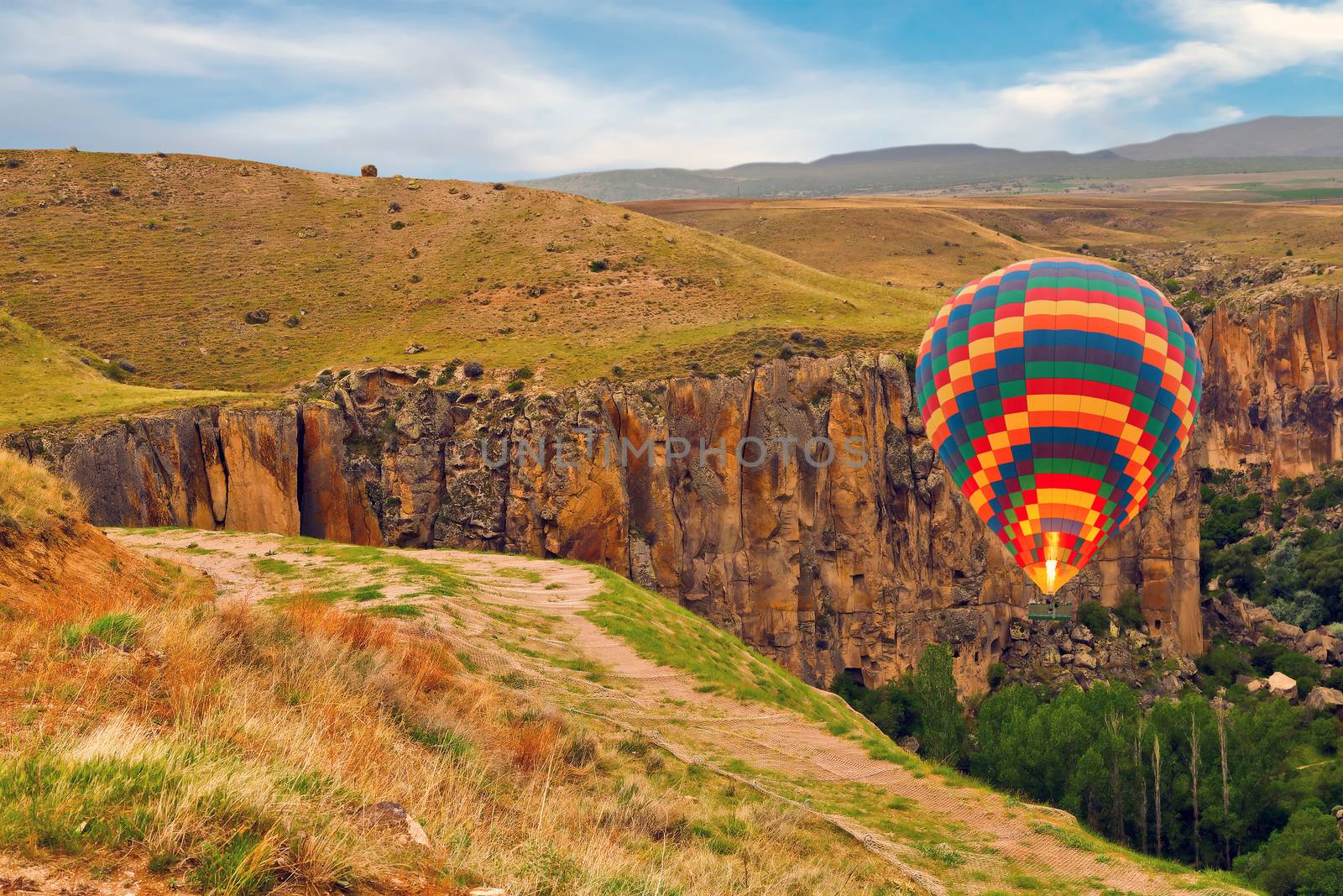 Hot air balloons landing mountain in national park Canyon Ihlara, Cappadocia, Turkey ballooning