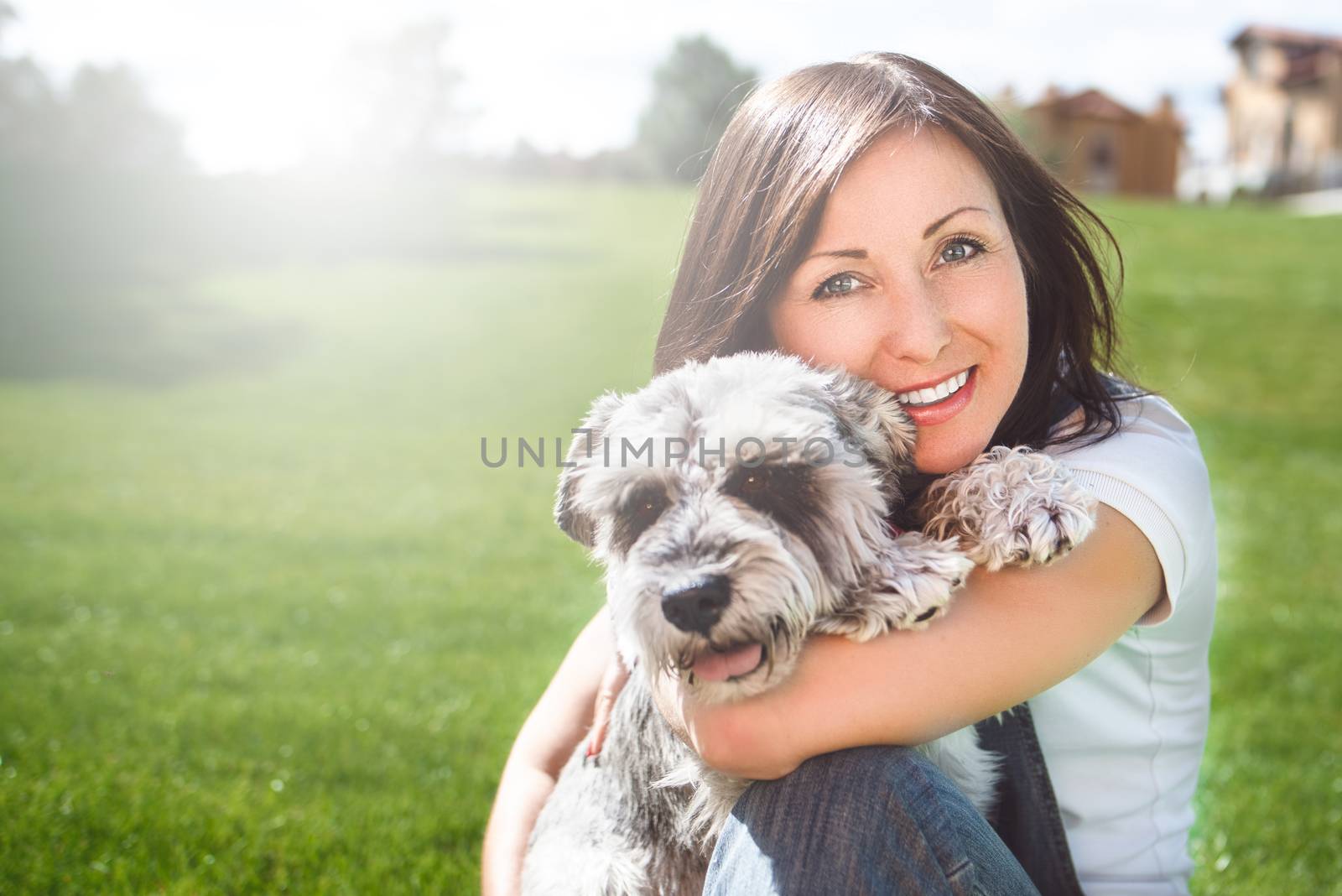 Portrait of a happy caucasian woman who hugs her beloved dog.The concept of love for animals. best friends. Dog breed Schnauzer by Nickstock