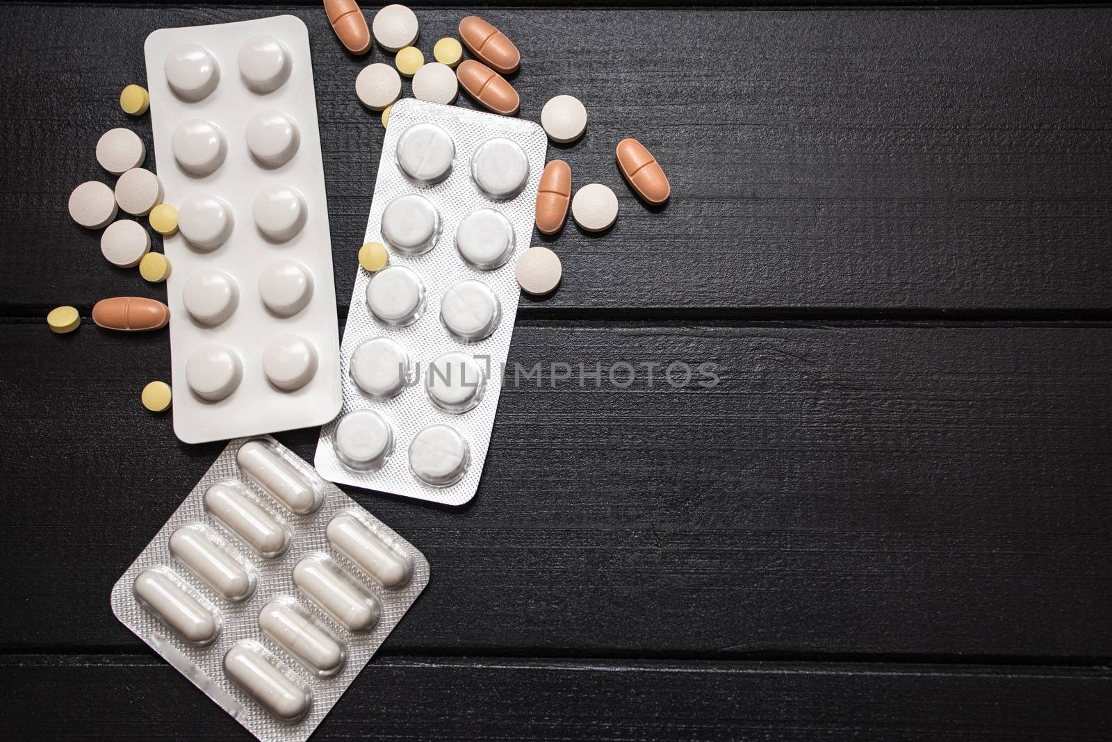 Medical Tools, Syringe and Colorful Drugs and Capsules Medicine Concept, Brown Wood Background, Front View, Close Up, Isolated