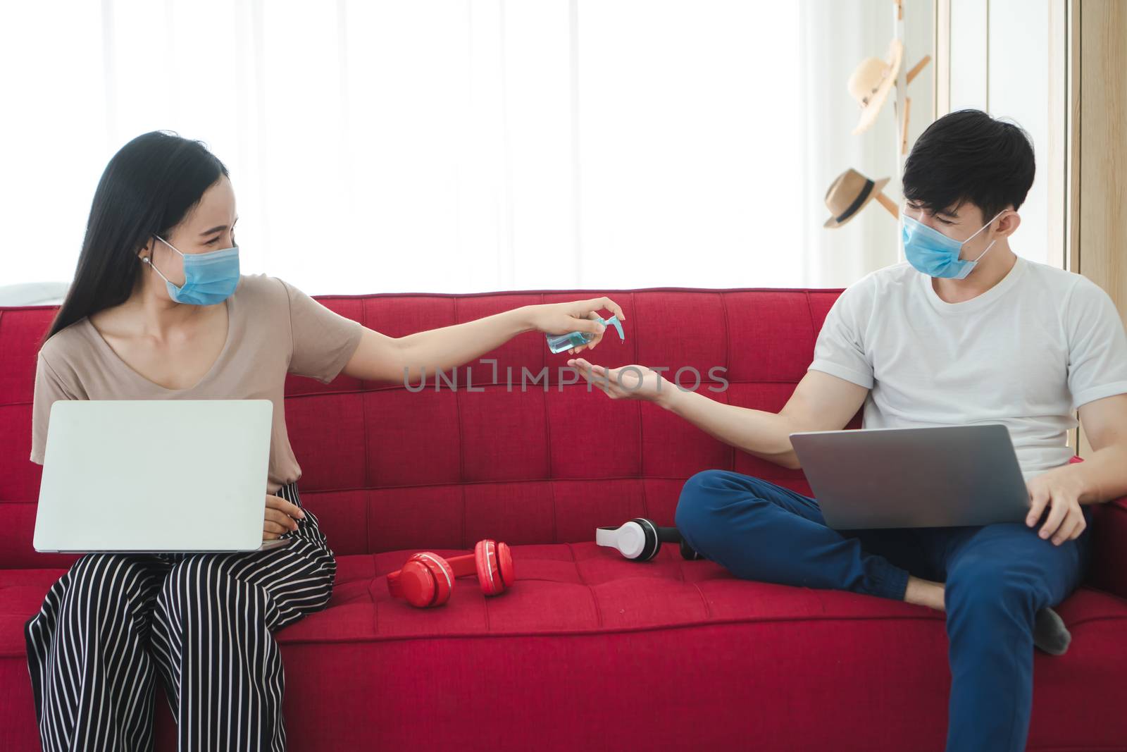 Asian men and women wear medical masks, work from home. Is a distance from society To prevent the spread of Coronavirus