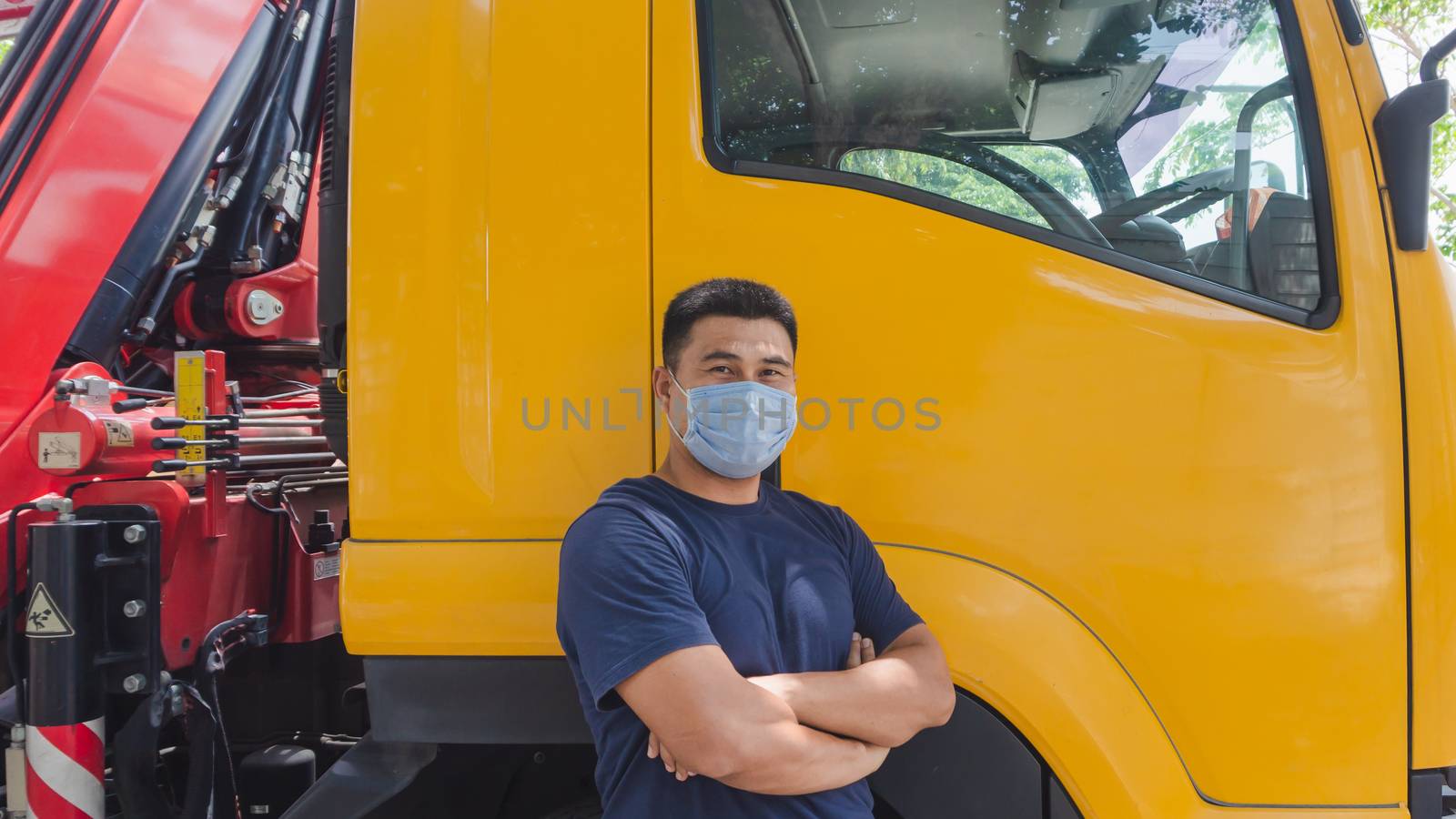 Close-up photos of Asian truck drivers wearing masks to protect against dust and the spread of the flu. Covid 19. Inside the car front