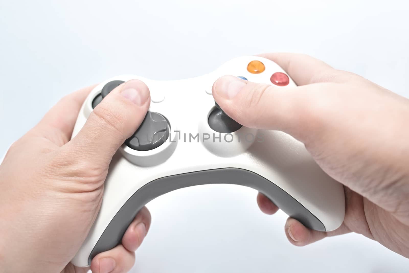 joystick gamepad in the player's hands isolated on white background