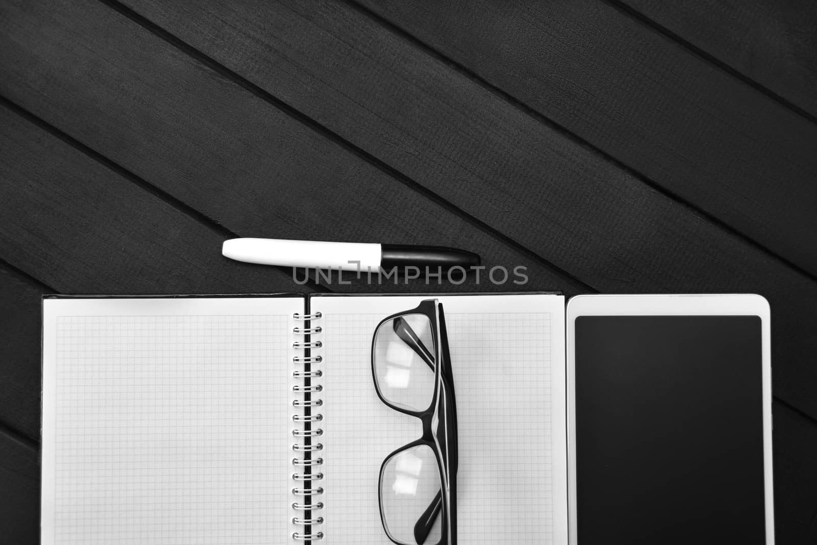 Top view of working space with white paper for text in wood clipboard pen and blank screen smart phone on wooden table with copy space. Work and study table concept