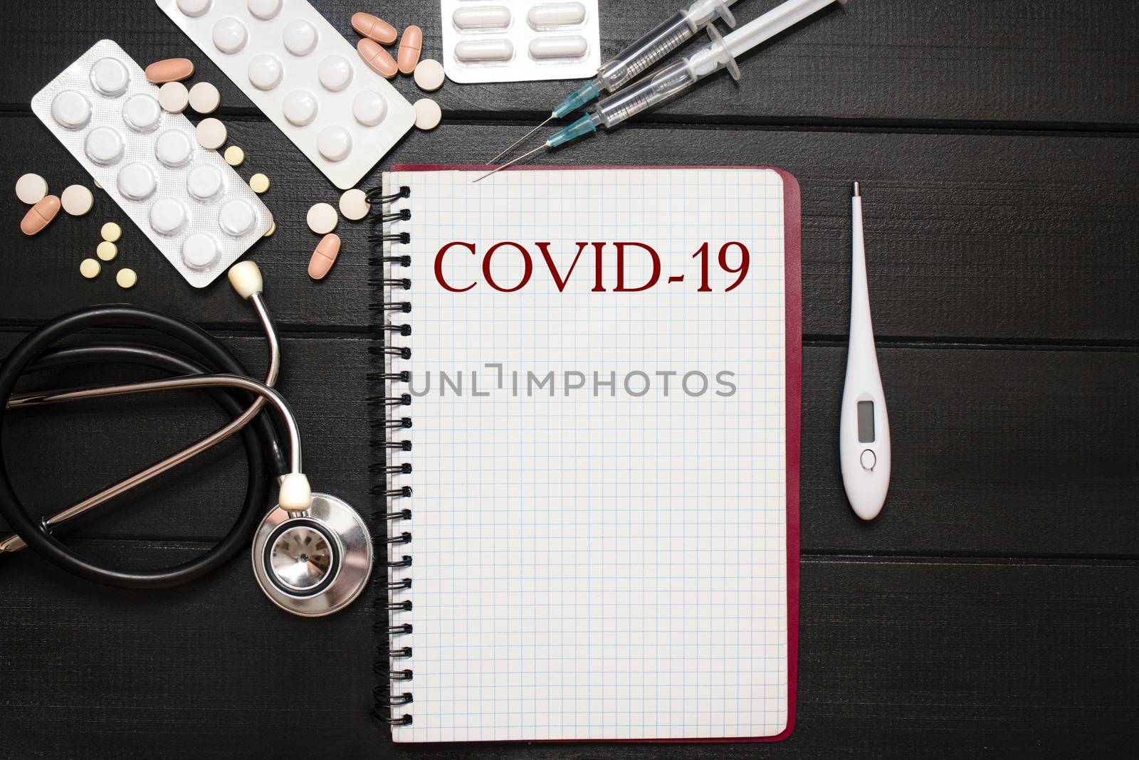 Coronavirus. COVID-19, Medical Tools, Syringe and Colorful Drugs and Capsules Medicine Concept, Brown Wood Background, Front View, Close Up, Isolated
