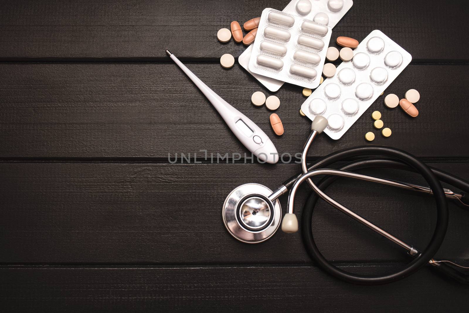 Medical Tools, Syringe and Colorful Drugs and Capsules Medicine Concept, Brown Wood Background, Front View, Close Up, Isolated