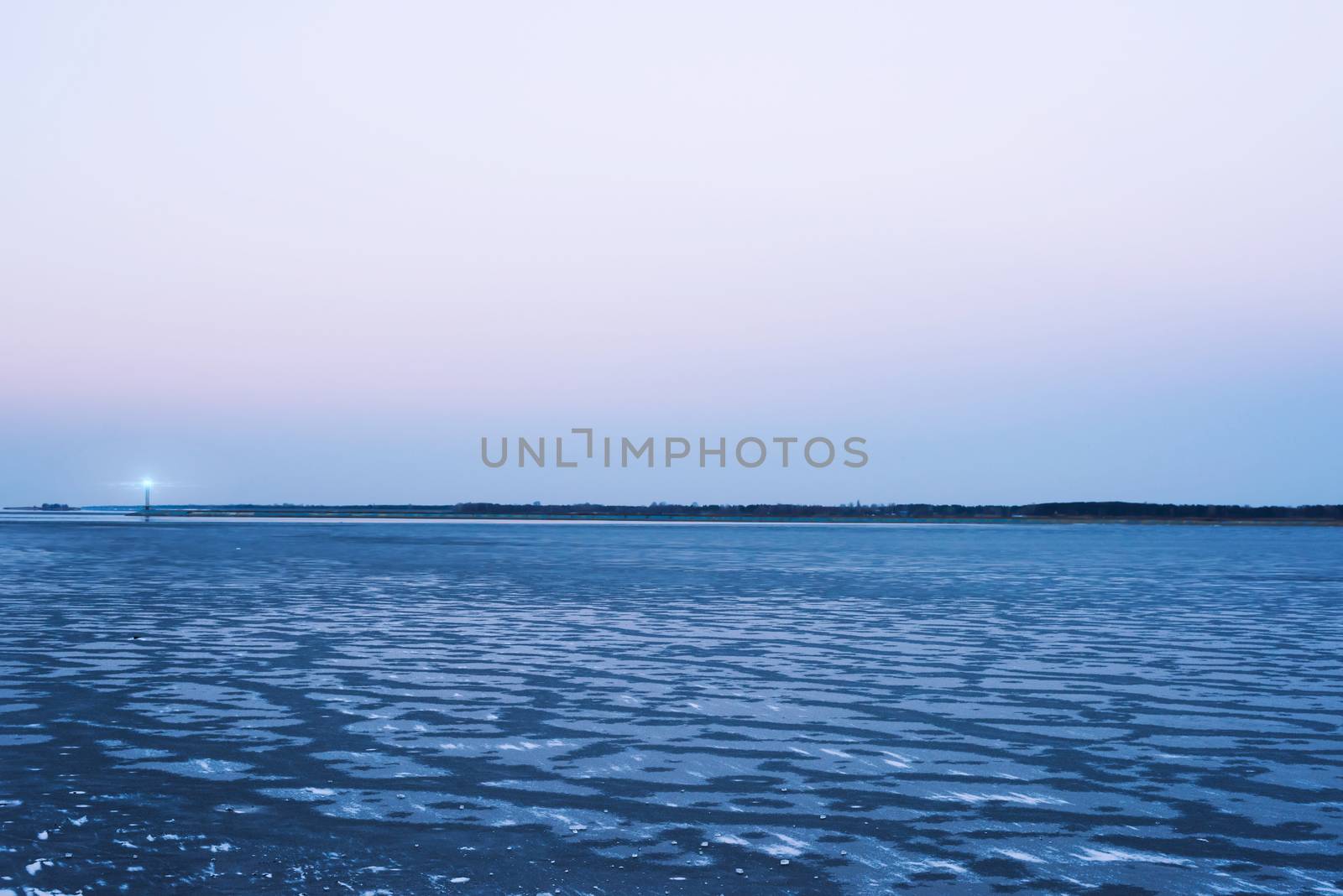 Frozen sea, the lighthouse, evening sky  romantic