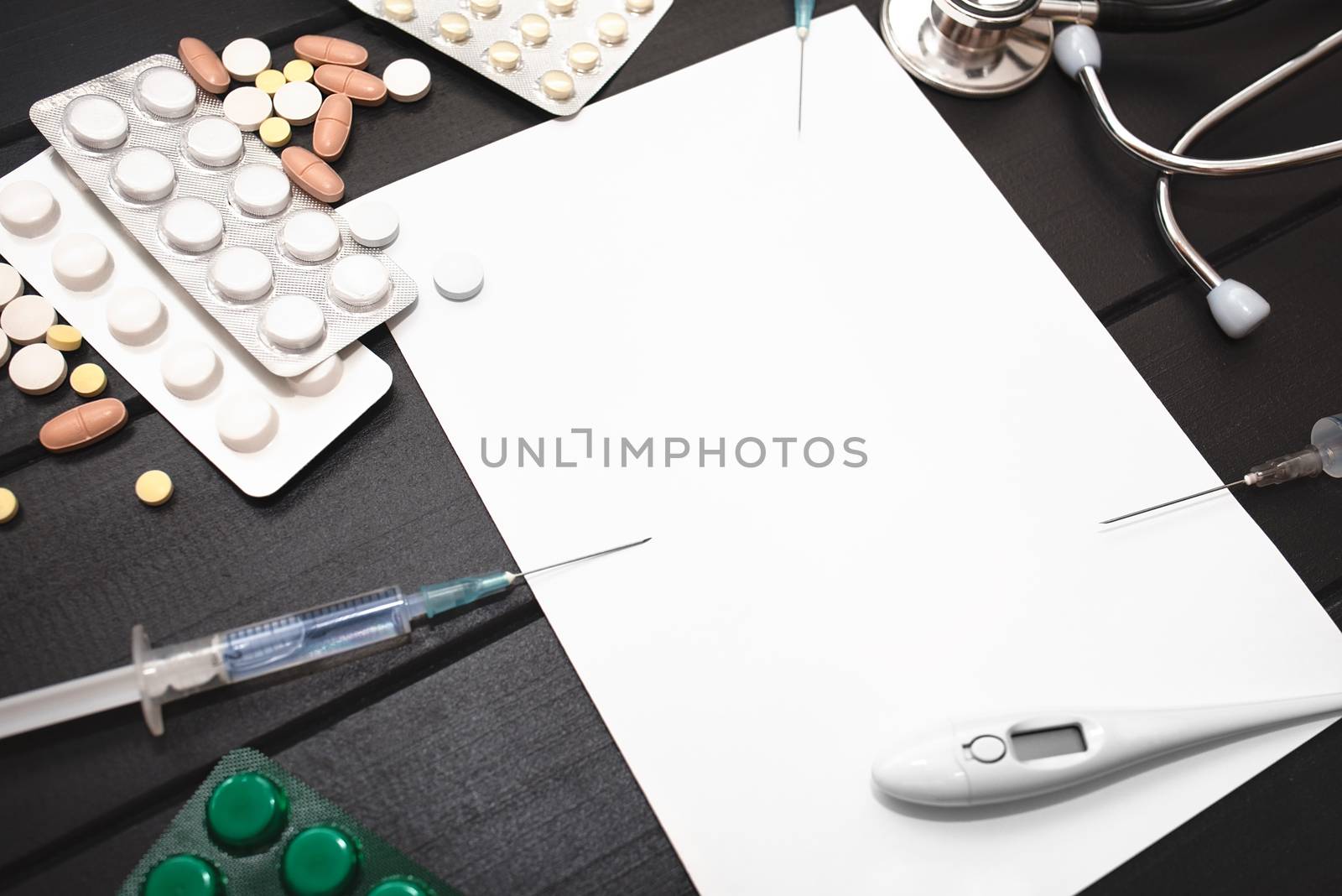 Medication prescription with pills and stethoscope lies on wooden table. Tablet or drug. Medicine and healthy concept. Copy space for text. Close-up. Indoors.