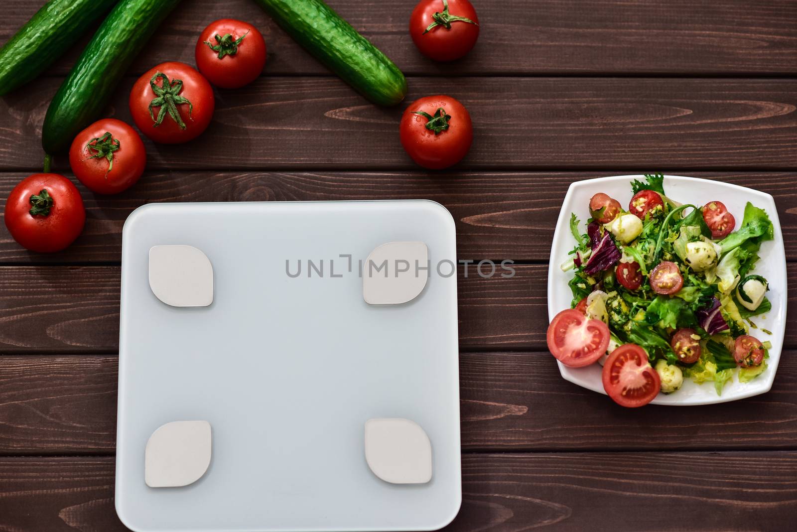 dieting and control calories for good health concept. salad. smart weight scales. veggies on board. fitness concept.