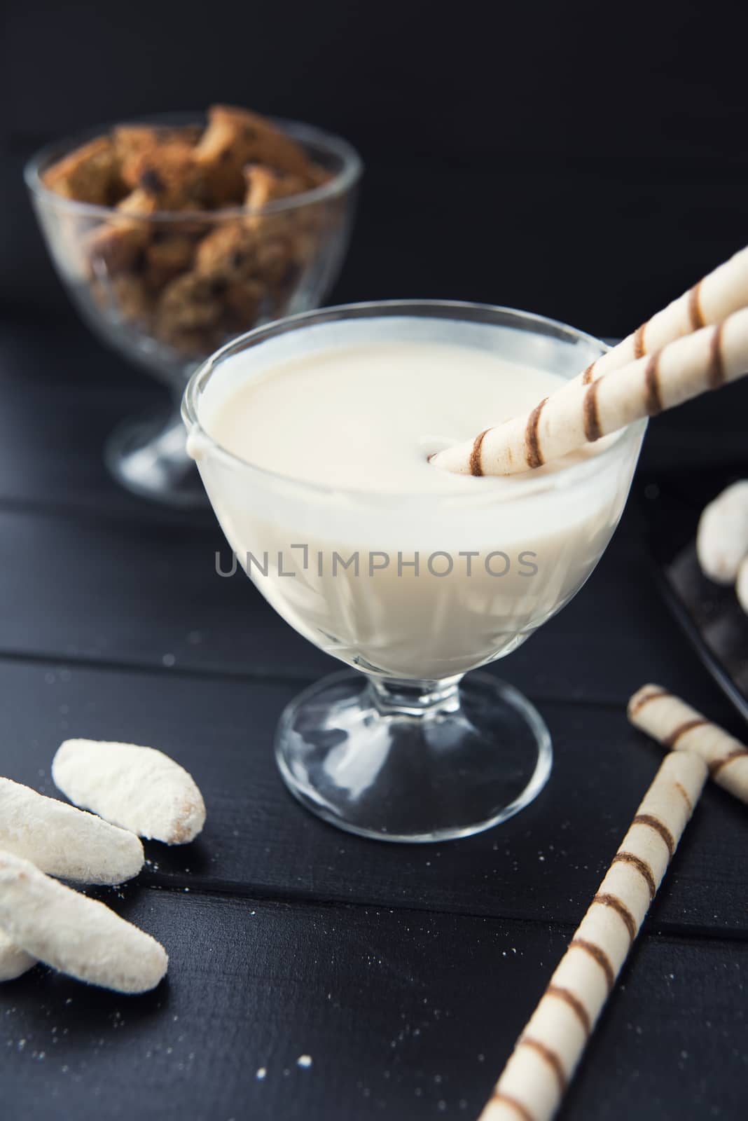 sweets, straws in the cream, cookies and candies on the table