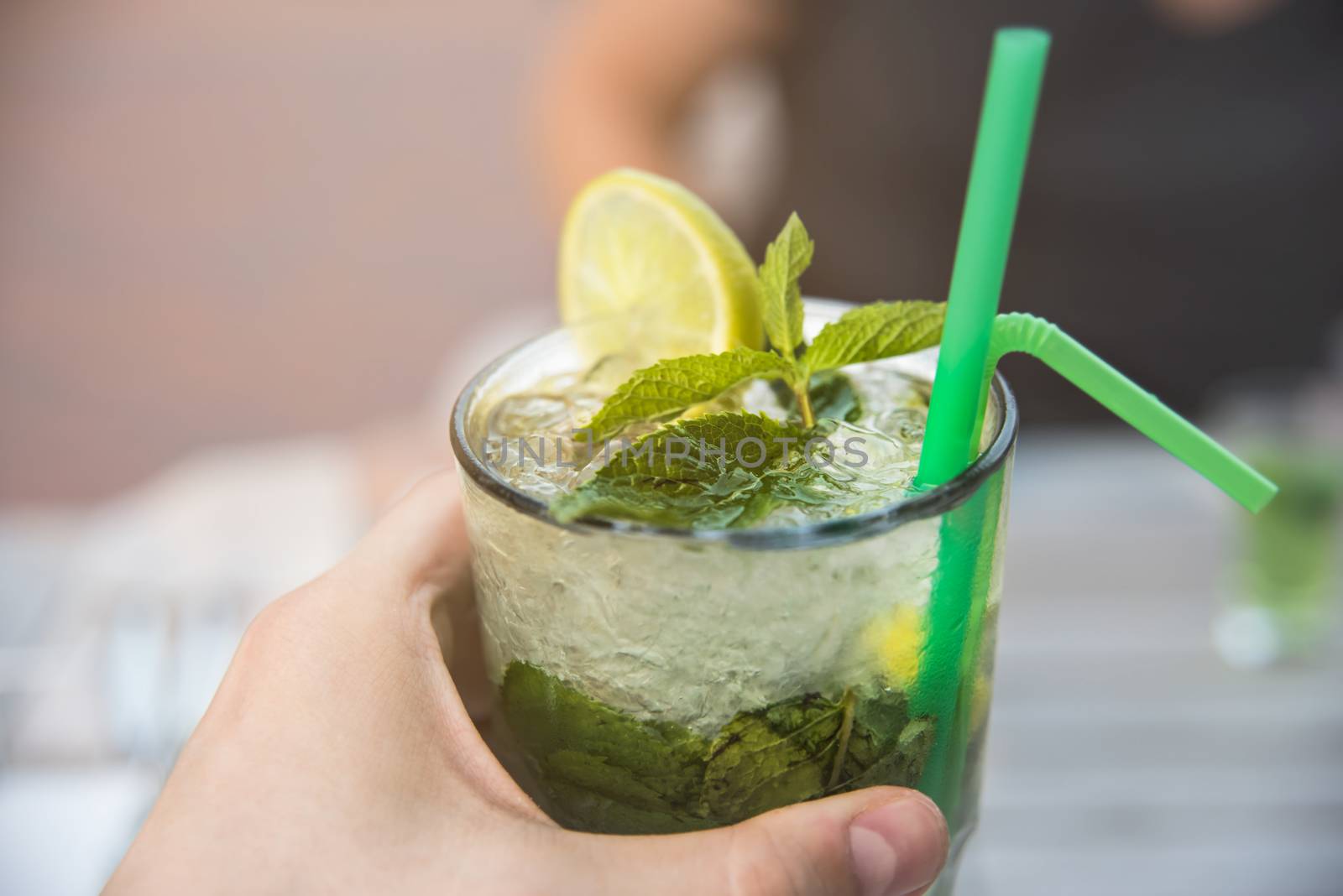 summer ice cocktail with mint in the hands