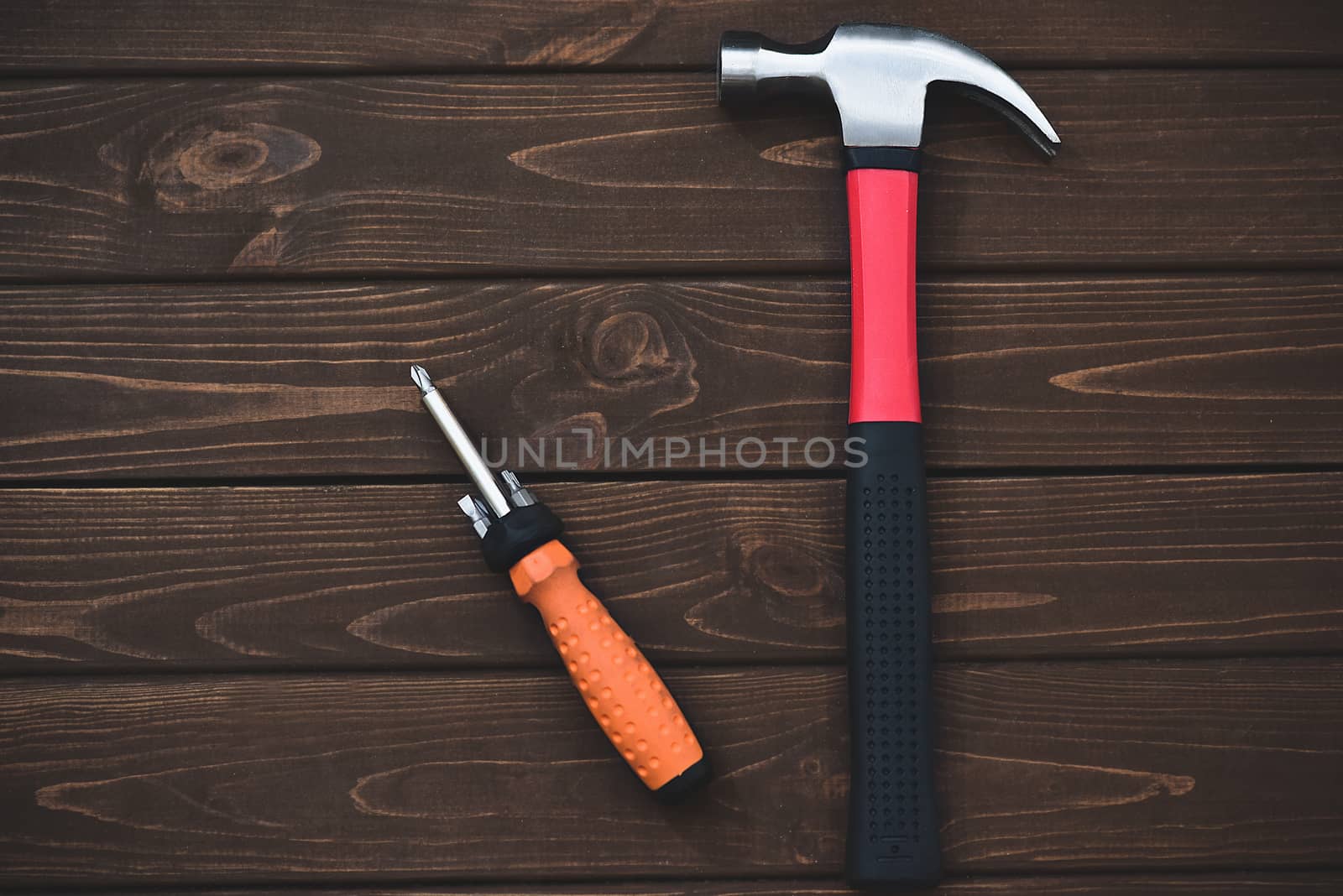 close-up tools as hammer and screwdriver on a wooden background. work concept.