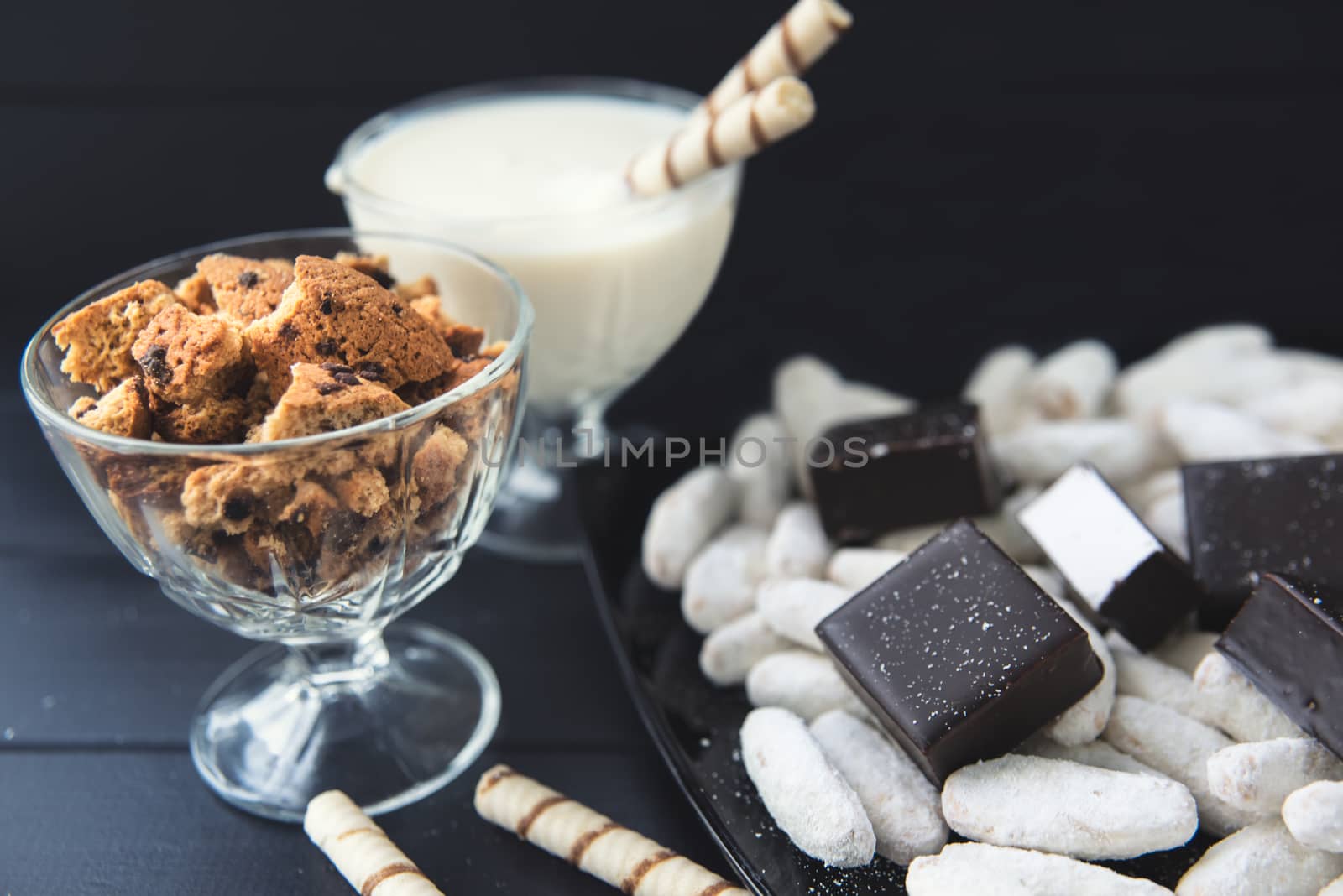 sweets, straws in the cream, cookies and candies on the table