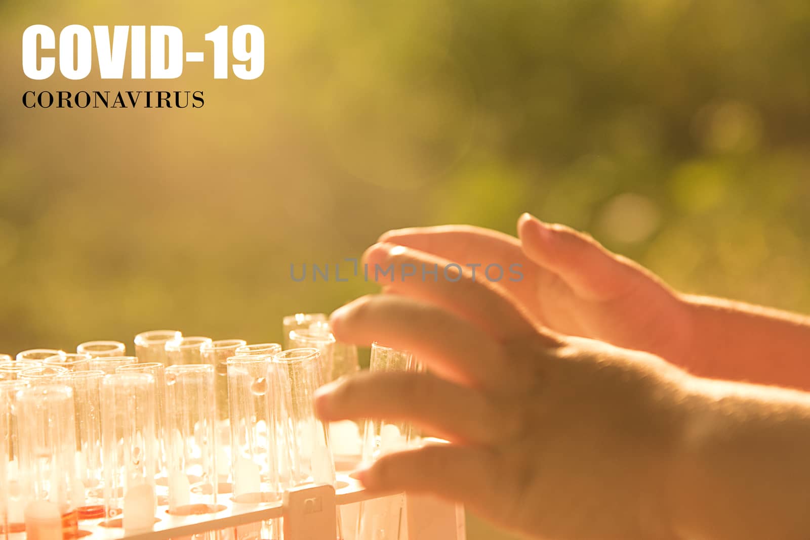 Little boy's hand and the test tube of the laboratory. The concept of caring for children from Covid-19.