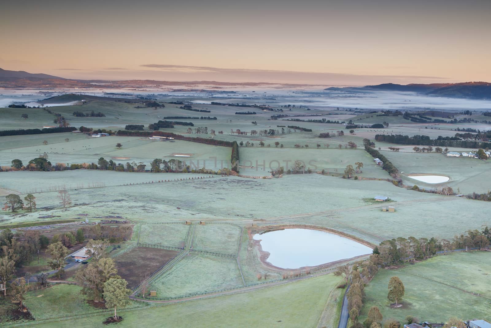 A view across a valley at sunrise in the Yarra Valley in Victoria, Australia