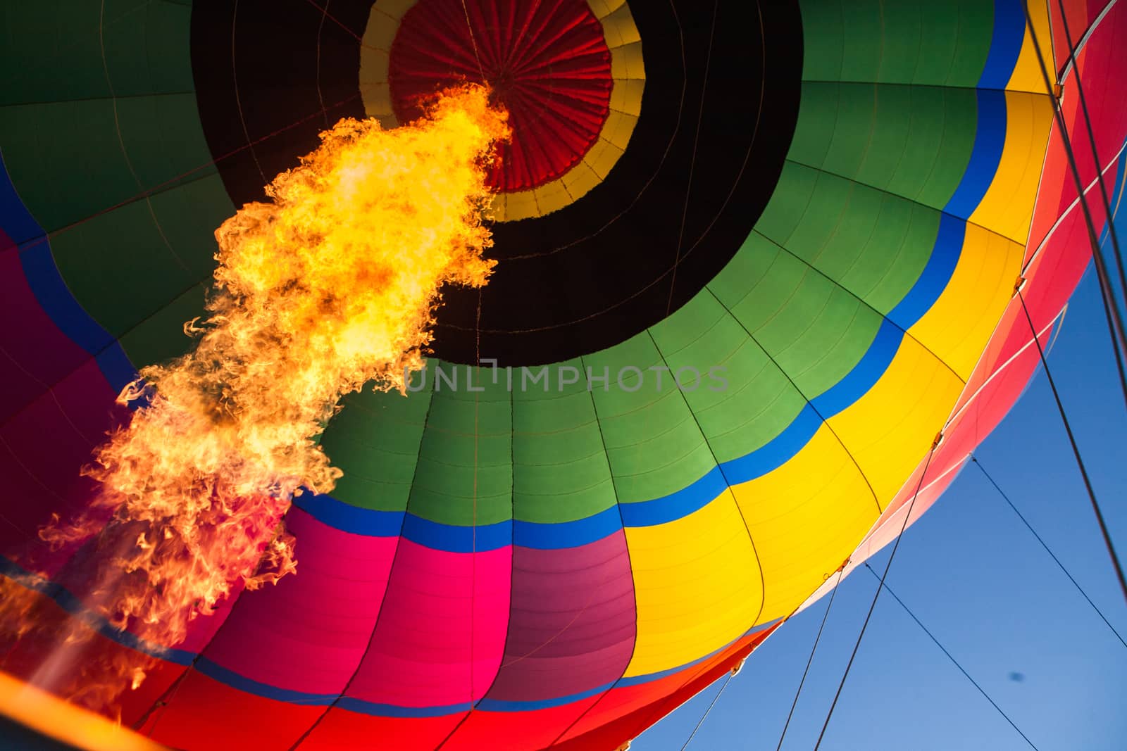 A blast of gas ignites, filling a hot air balloon with warm air on a cold winter's morning in Yarra Valley, Victoria, Australia