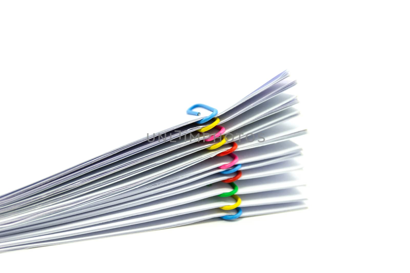close up of Stack of papers files piles of unfinished documents achieves with paper clips 
