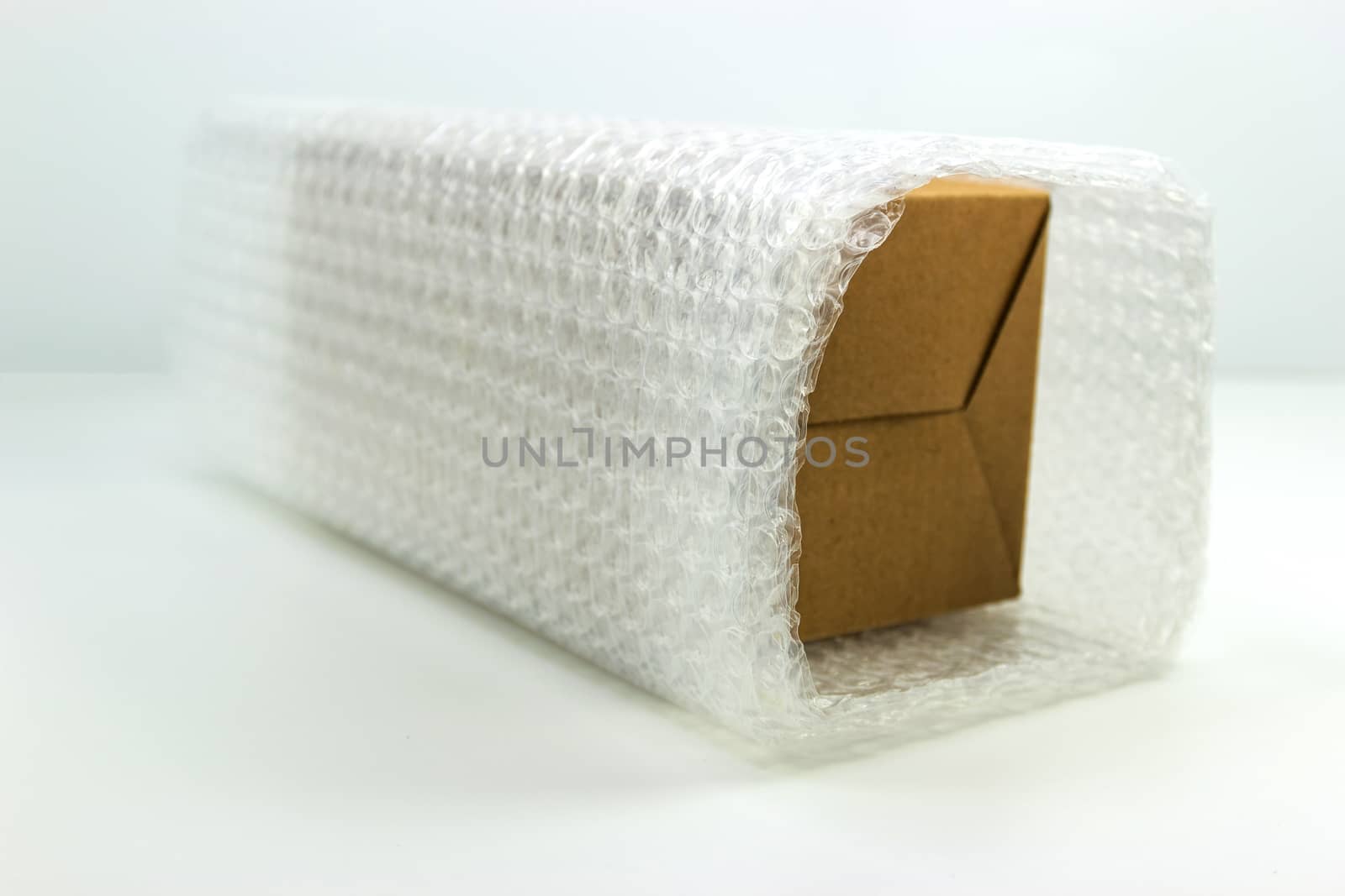 Bubbles covering the box by bubble wrap for protection product cracked white background