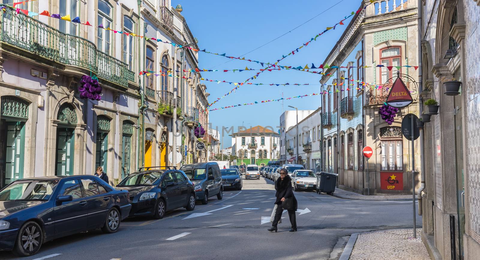 Ovar, Portugal - February 18, 2020: architectural detail of the typical houses of the city decorated for the carnival where people are walking on a winter day