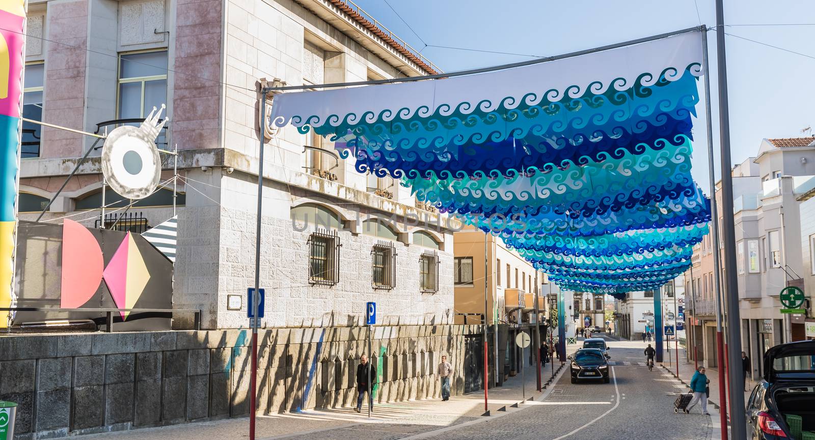 Ovar, Portugal - February 18, 2020: architectural detail of the typical houses of the city decorated for the carnival where people are walking on a winter day