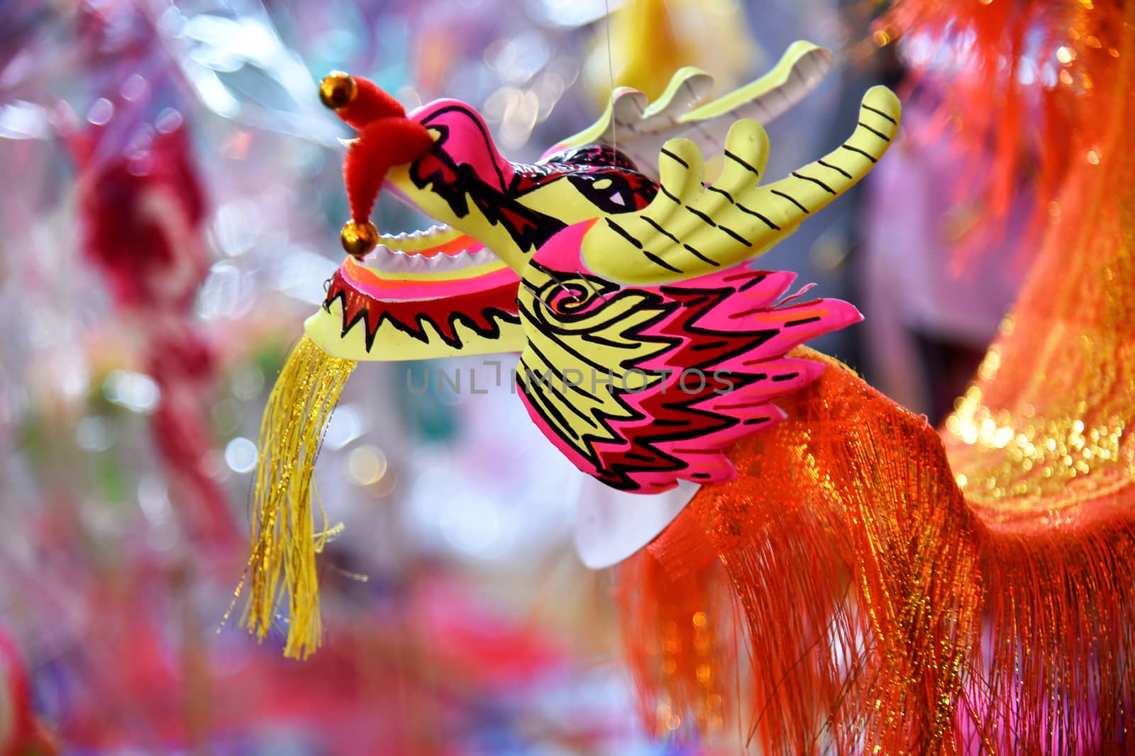 Bright colorful Dragon and Lion puppet paper toys being sold during a cultural chinese festival in Northern Thailand, Southeast Asia