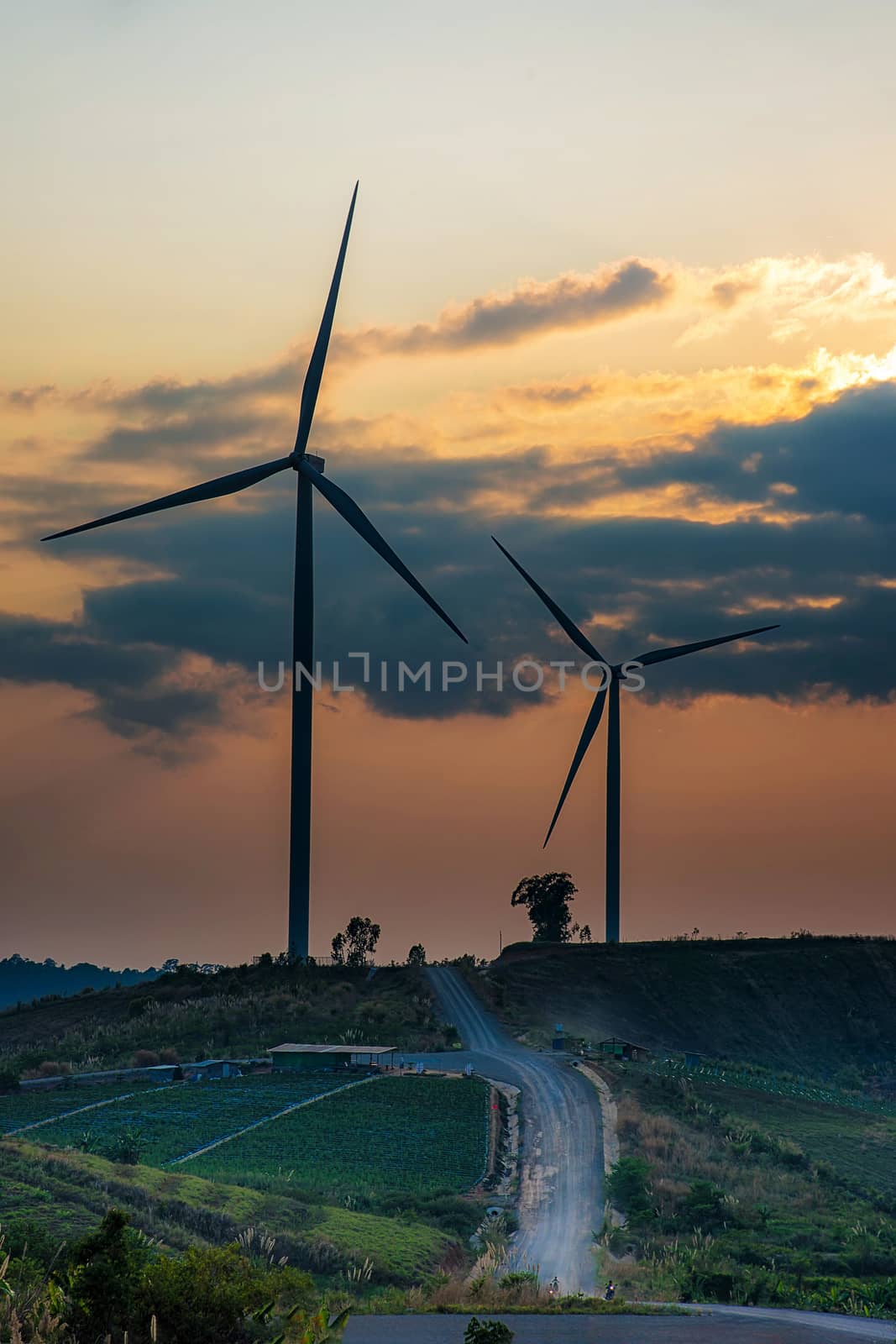 Wind Turbines over a sunset background. by NuwatPhoto