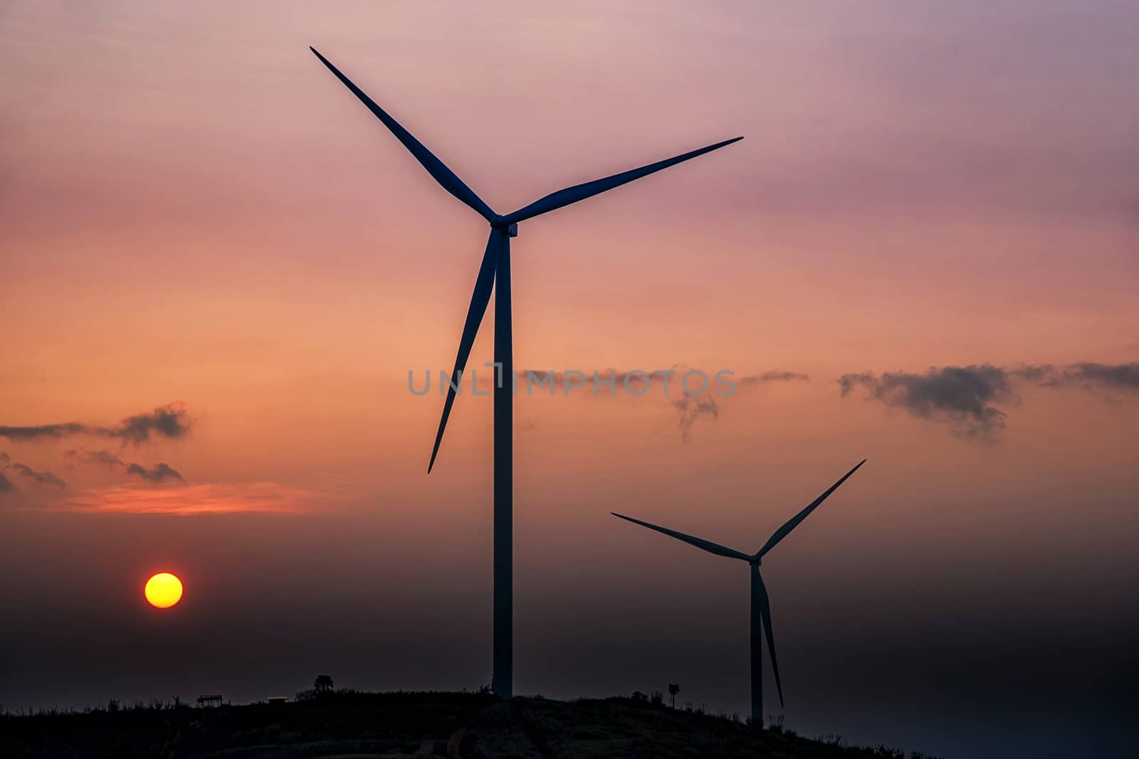 Wind Turbines over a sunset background. by NuwatPhoto